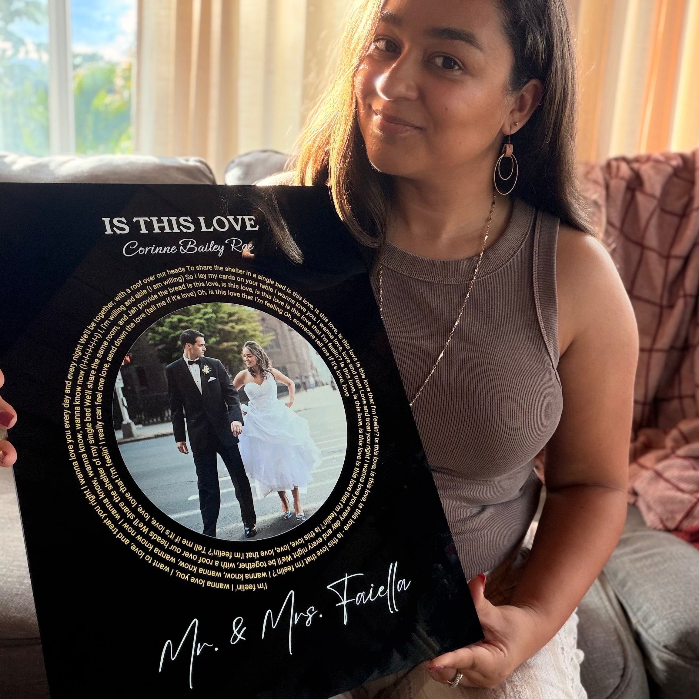 Couple holding custom Timeless Track song plaque gift